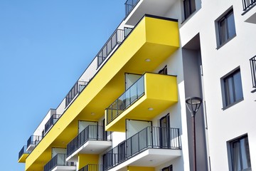 Fototapeta premium Modern apartment buildings on a sunny day with a blue sky. Facade of a modern apartment building
