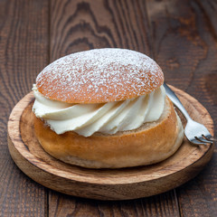 Traditional swedish dessert Semla, also called Shrove bun, with almond paste and whipped cream filling, square