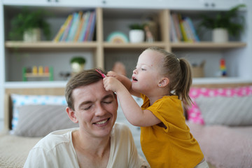 Caucasian father and daughter, girl playing dad