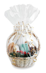 gift basket packed in transparent paper with a big bow isolated on a white background