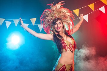 Carnival, belly dance and holiday concept - Beautiful female samba dancer wearing gold costume and smiling