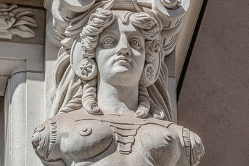 Old wall sculpture of a sensual woman warrior in chain armor as defender with lion head in downtown of Dresden, Germany