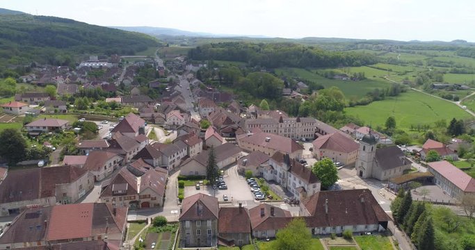 Mouchard village and train station, aerial back traveling, Jura, France