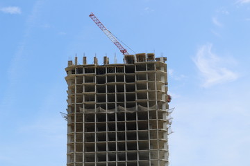 Construction site with cranes on sky background