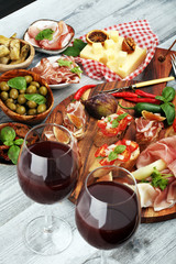 Italian antipasti wine snacks set. Cheese variety, Mediterranean olives, Prosciutto di Parma, tomatoes, artichokes
