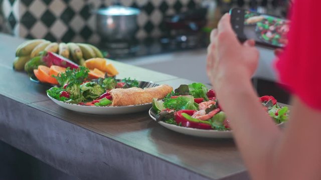 Woman Taking Pictures of Salad with Fresh Vegetables and Shrimps on her Camera Close UP 4K. 