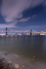 Manhattan Bridge from East river beach at night with long exposure