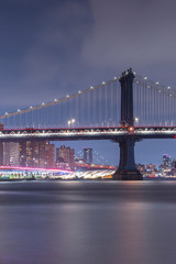Fototapeta na wymiar Manhattan Bridge from East river beach at night with long exposure
