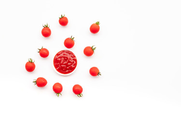 Fresh tomato with tomato sauce on small dish on white background.Organic food and vegetable concepts