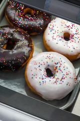 Delicious donuts on store shelves, close-up 
