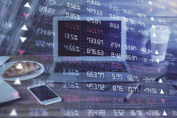 Financial chart drawing and table with computer on background. Multi exposure. Concept of international markets.