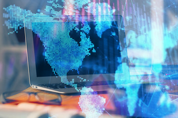 Stock market graph on background with desk and personal computer. Multi exposure. Concept of financial analysis.