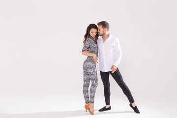 Social dance concept - Active happy adults dancing bachata or salsa together over white background...