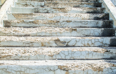 abandoned, crumbling cement outdoor staircase on a sunny day