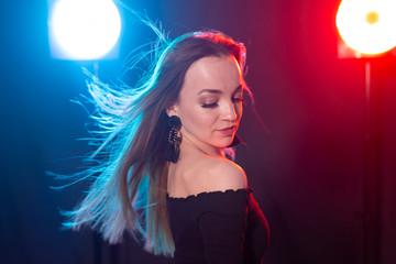 Portrait of young sexy woman with flashes on background