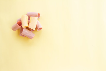 Uncooked pasta on neutral background. Meal based on flour. Italian healthy food. Copy space