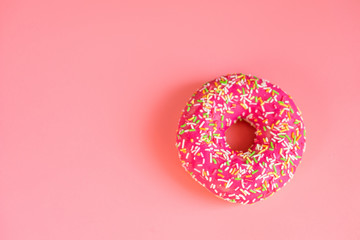Fototapeta na wymiar Round pink donut on pink background copy spase for text