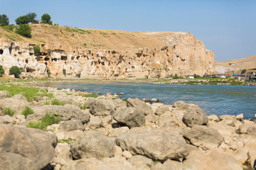 The view of the Tigris River and surrounding ancient cave houses in the town of Hasankeyf, Turkey,...