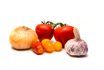 Onion, garlic and tomatoes isolated on white.