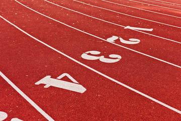 Stadium running track with red coating and numbers closeup