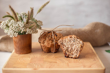 Sliced ​​cupcake on a wooden tray. Muffin is dietary, sugar free, whole grain flour. Healthy lifestyle.