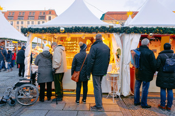 People at Stalls at Christmas market on Gendarmenmarkt in Berlin - obrazy, fototapety, plakaty