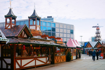 People at Christmas market in Alexanderplatz in Berlin - obrazy, fototapety, plakaty