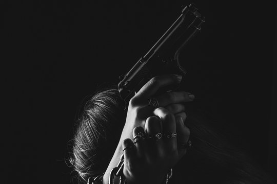 The woman is distraught with a gun