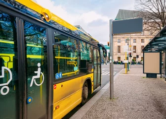 Fototapeten Yellow bus with entrance door for people with disability Berlin © Roman Babakin