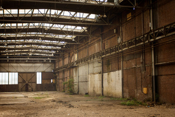 Fototapeta na wymiar Abandoned empty old factory workshop interior