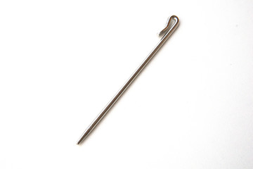 Needle like metal object isolated on white background. This can be used for sewing as well as tidying hair for Sikh boys and men.