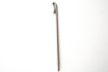 Needle like metal object isolated on white background. This can be used for sewing as well as tidying hair for Sikh boys and men.