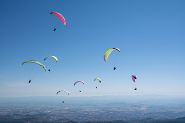 Group of paragliders enjoy a thermal updraft in Puy de Dome, Auvergne, French   Massif Central. France