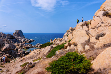 Fototapeta na wymiar Couple looking at rocks of Capo Testa Sardinia