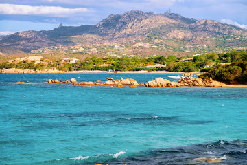 Romantic sunny sunrise at Capriccioli Beach of