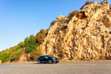 Car and road in in Sardinia Island hills