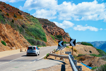 Car at road in in Sardinia Island hills