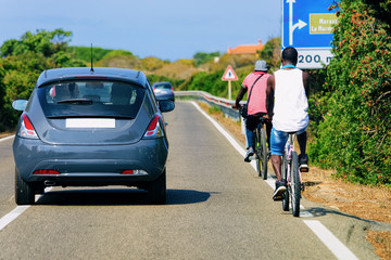 Bicycles and cars in the road in Costa Smeralda