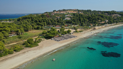 Fototapeta na wymiar Aerial drone photo of iconic exotic sandy peninsula and sandy beach of Possidi with turquoise clear sea, Kassandra, Halkidiki, North Greece