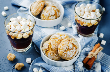 Pumpkin cookies with cups of coffee and marshmallow