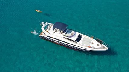 Fototapeta premium Aerial drone photo of luxury yacht docked in tropical Caribbean bay with turquoise open ocean sea