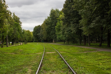 Fototapeta na wymiar Old railway track in the middle of the park