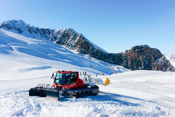 Fototapeta na wymiar Ratrack machine making ski piste on Hintertux Glacier in Zillertal