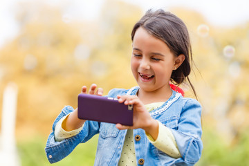 little girl in park in autumn, selfie photo