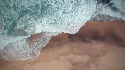 Aerial view waves break on white sand beach. Sea waves on the beautiful beach aerial view drone