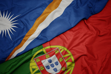 waving colorful flag of portugal and national flag of Marshall Islands , .