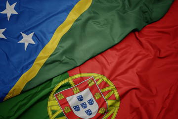 waving colorful flag of portugal and national flag of Solomon Islands , .