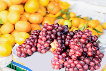Naklejka na ściany i meble Asian fruit assortment such as grapes and orange Hoi An