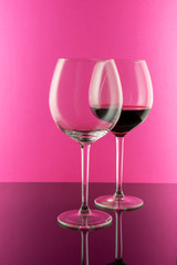Studio shot of a glass of red wine isolated on pink background closeup. Clean and minimal. Wine concept. 