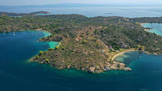 Aerial drone panoramic photo of iconic exotic bay known as blue lagoon in Diaporos island with turquoise clear sea, Vourvourou, Sithonia Peninsula, Halkidiki, North Greece © aerial-drone